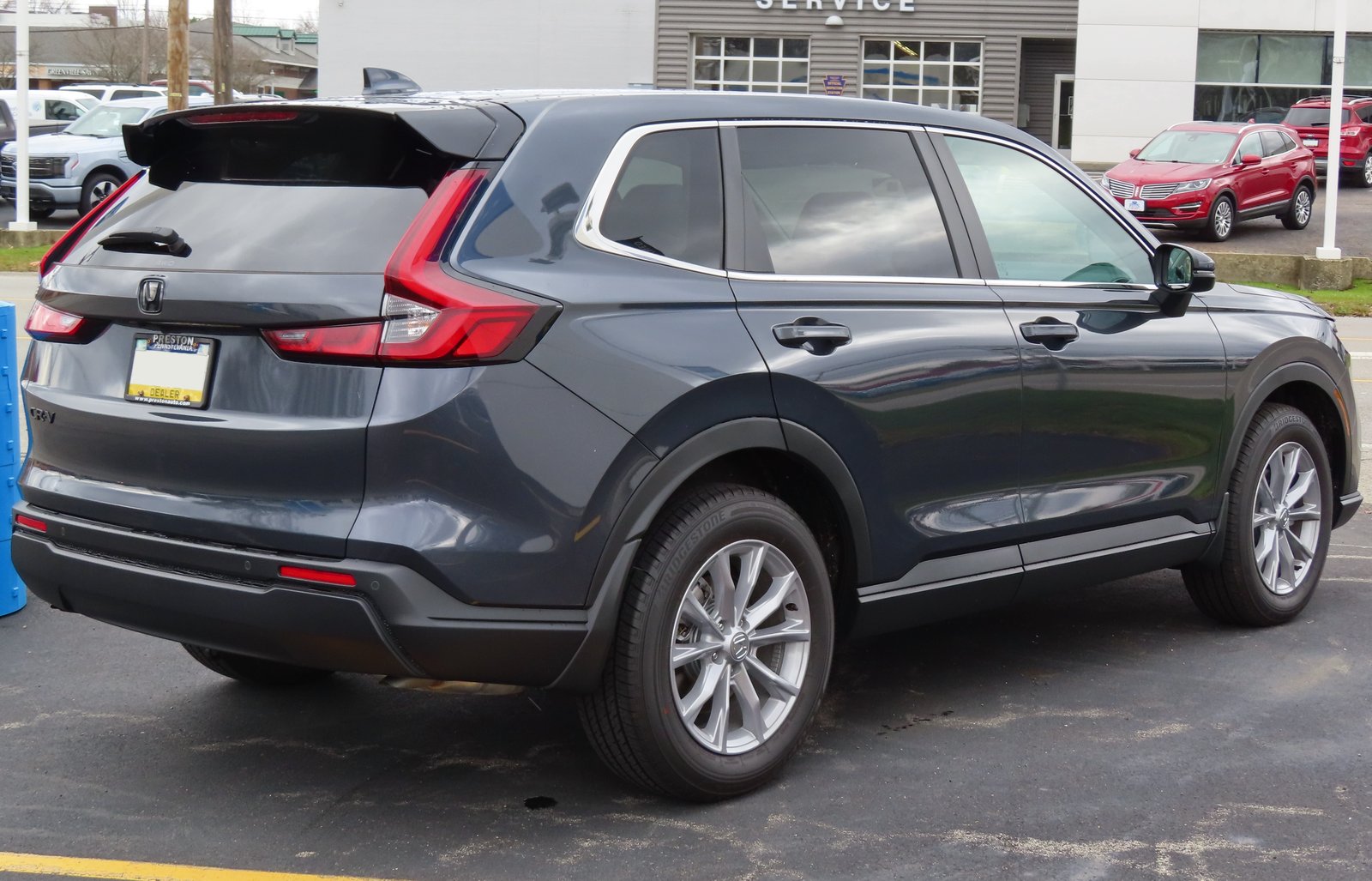 2023 Honda CR-V EX-L in gray, rear three-quarter view