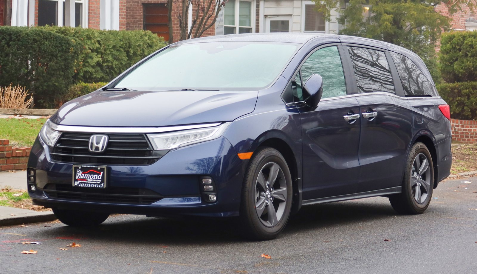 White fifth-generation Honda Odyssey minivan, front three-quarter view